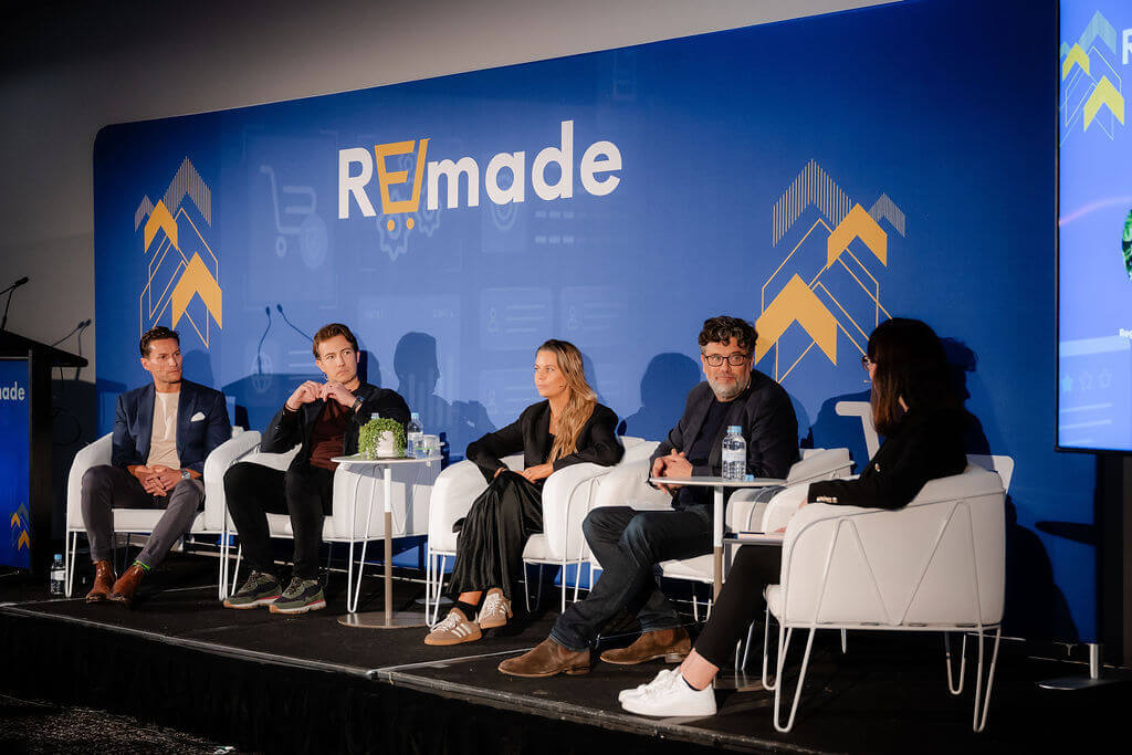 Panel discussion at Mumbrella REmade 2026, with five speakers seated on stage in front of a blue REmade backdrop.